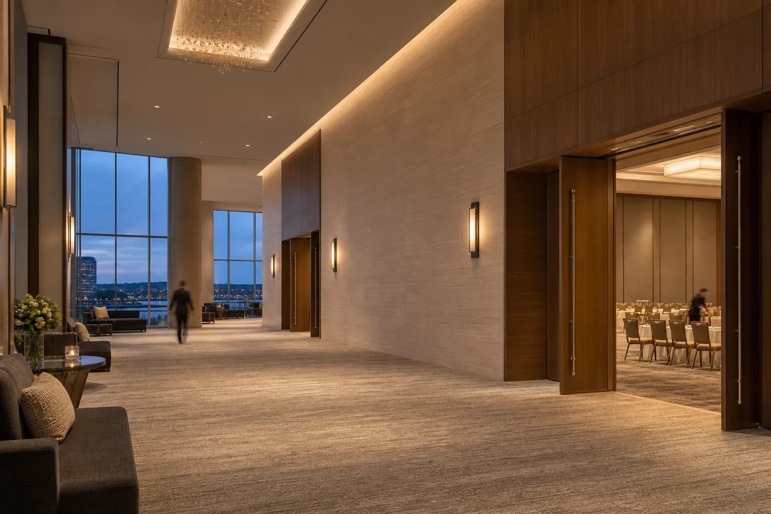 An upscale convention hotel pre-function hall in soft evening light.