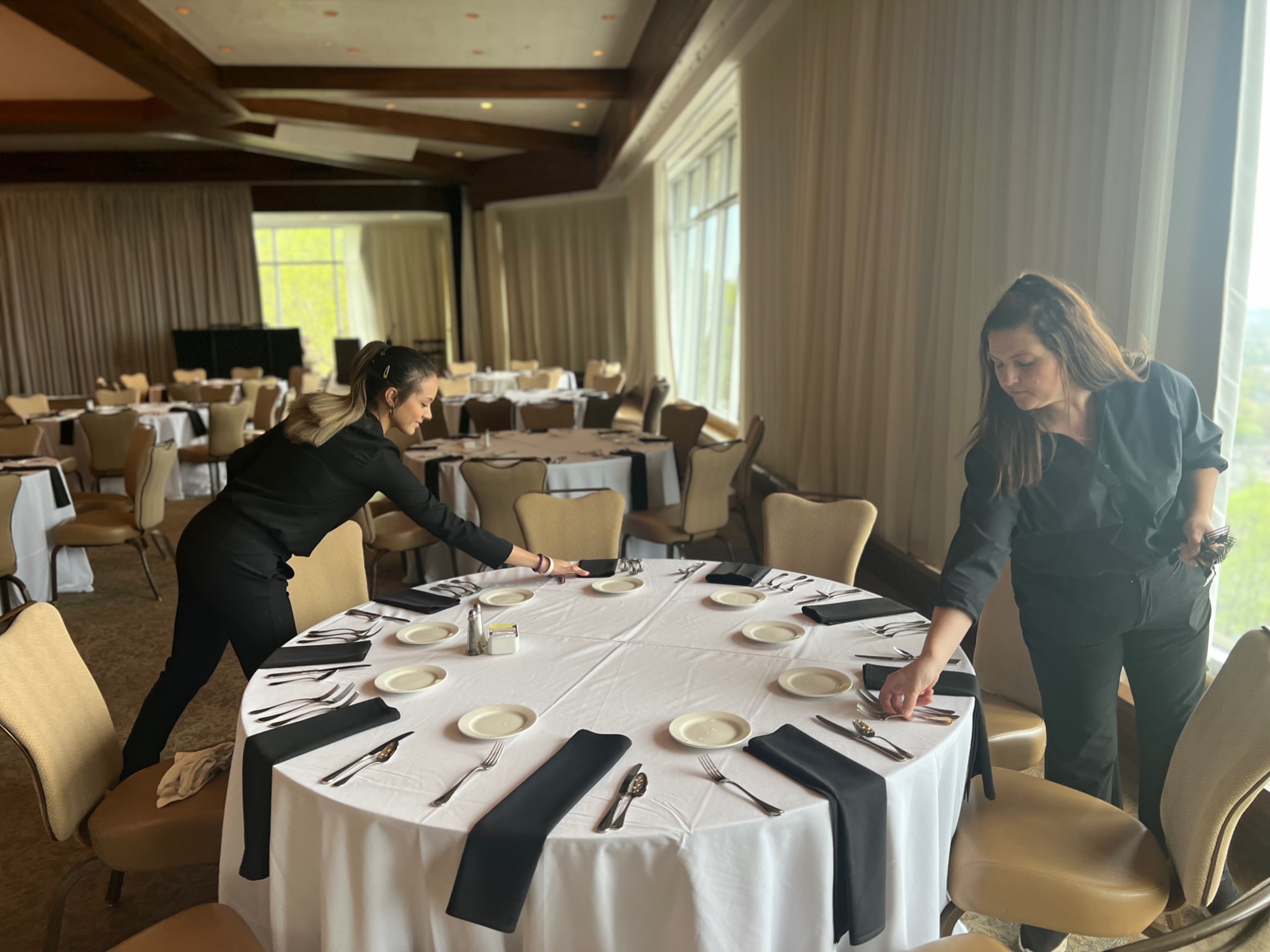 Croux talent setting tables in ballroom